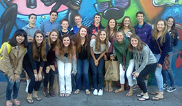 youth group mosaic, Posing for a photo in front of a spray painted wall.