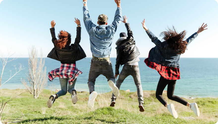 A group of young people jumping in the air.
