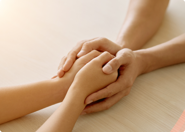 Hands being held by another set of hands.